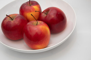 four apples in a bowl
