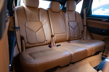 Obraz premium The interior of the car with a view of the rear seats and doors with light brown leather trim