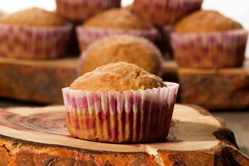 homemade muffins with coconut chips on a wooden stand