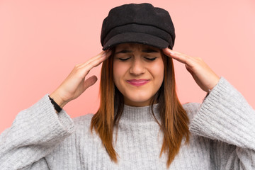 Fashion woman with hat over pink wall unhappy and frustrated with something. Negative facial expression