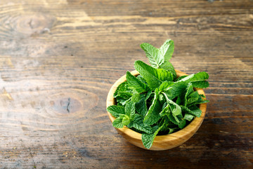 fresh mint in a wooden plate
