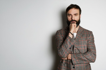 Handsome cheerful man standing over white background and looking camera. Mockup Copy Paste Advertisement