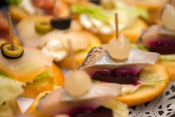 Sandwiches with herring and balyk on a plate.