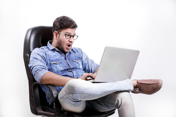  Young Indian man using laptop