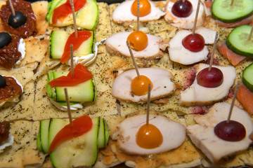 Meat sandwiches with sausage and ham on a plate.