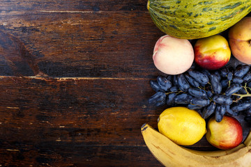 Obraz na płótnie Canvas different fruits on wooden background
