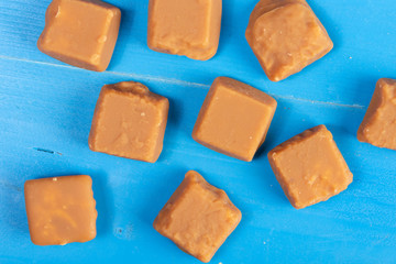 Brown Caramel Candies On The Blue Wooden Boards