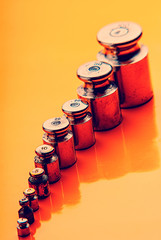set of old kettlebells on an orange background. Close-up.