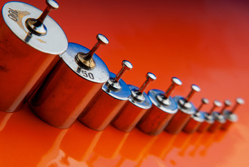 set of old kettlebells on an orange background.