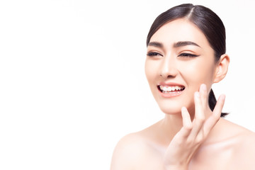 Obraz na płótnie Canvas Beautiful young asian woman touching her beautiful face and gets happiness with smiley face. Charming beautiful woman satisfied a product of facial skin care that makes get nice skin face copy space