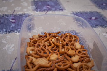 Salty snacks in the bowl on table