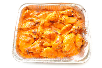 Spicy Hot Buffalo Wing Pieces in a Takeout Container 