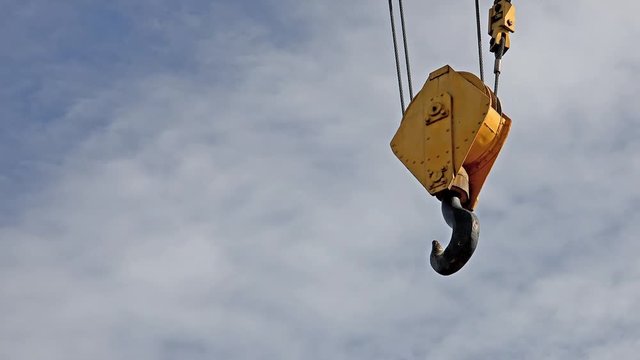 Crane hook with clouds time lapse in the background