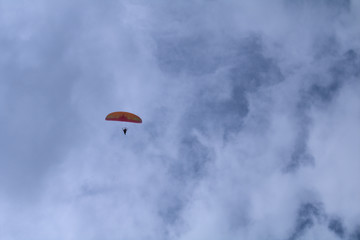 paraglider in the sky,motorized,parachute, blue, paragliding, flying, sport, fly,clouds, air, adventure, extreme, freedom,fun,  