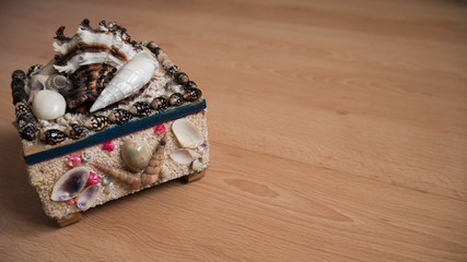 a box of jewelry made of shell on a wooden surface