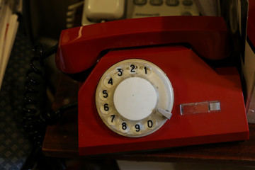 Old analog dial telephone red. Red old phone