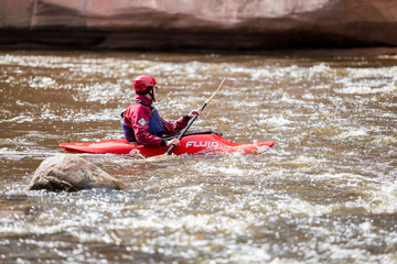Rafting, man with boat, river Gauja. Waves and sunny day. Travel photo 2019.