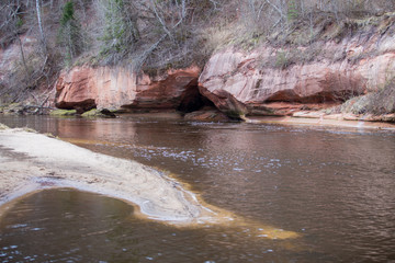  Red rocks and river Gauja. Nature and sun in spring. 2019.