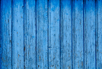 A fence of dark blue and grey turquoise boards. Blank background with a texture of wooden slats