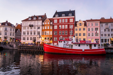 Nyhavn or New harbour is a 17th-century waterfront, canal and entertainment district lined by brightly coloured townhouses and bars, cafes and restaurants, Copenhagen, Denmark.