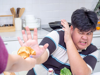 Asian fat man reject unhealthy food from another people