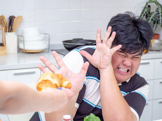 Asian fat man reject unhealthy food from another people