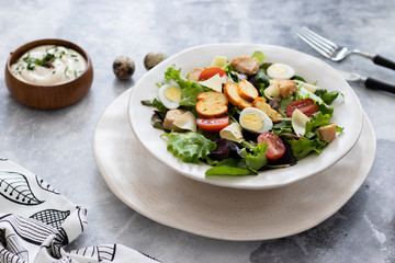 Caesar salad with quail eggs and croutons