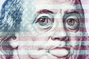 Big eyes of Benjamin Franklin with a hundred dollar bill, a symbol of inflation, appreciation, devaluation, close-up