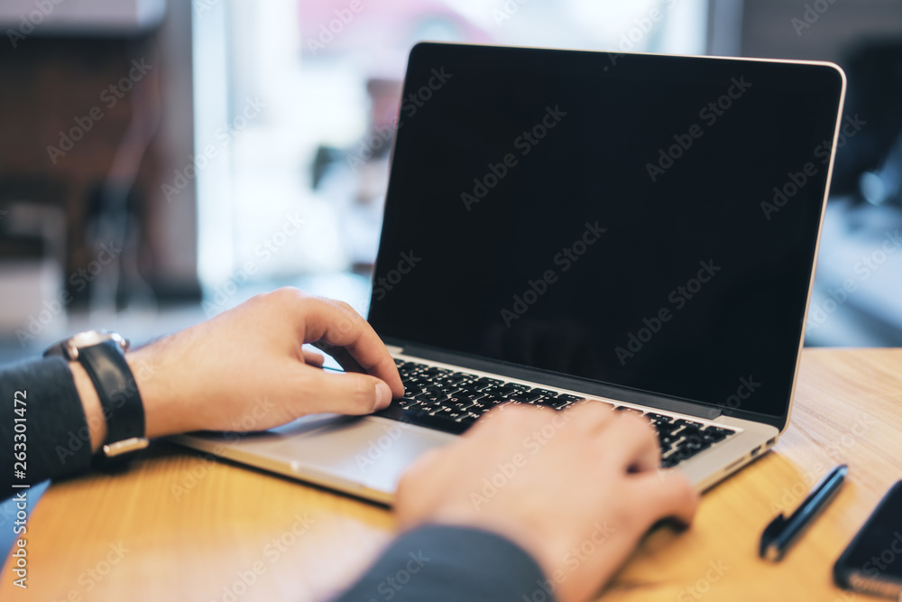 Poster man using empty laptop screen on desk