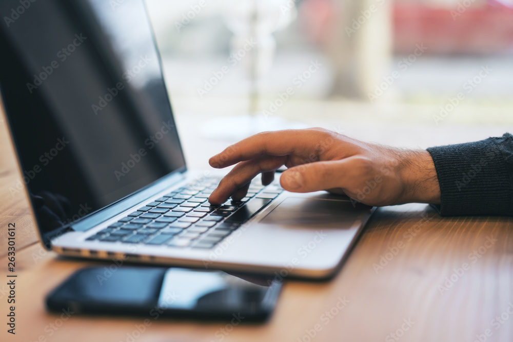 Poster sideview of man using devices on table