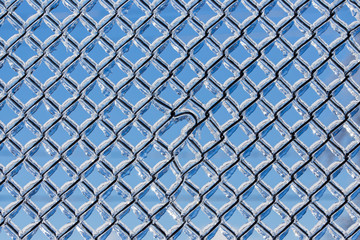 Abstract background with ice on metal fence