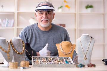 White bearded old jeweler at workshop 