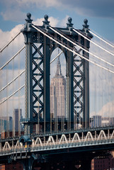 Fototapeta premium New York City, USA - June 7, 2010: Detail of the Manhattan Bridge with the Empire State Builing on the background, in the city of New York City.