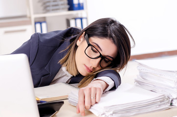 Young female employee sleeping in the office