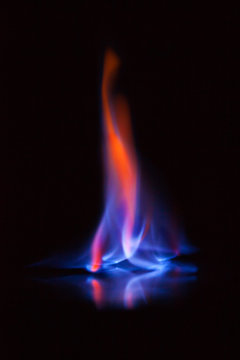 Flame of burning alcohol on black background. Gas flame. Black background. Abstract blaze fire flame texture background.