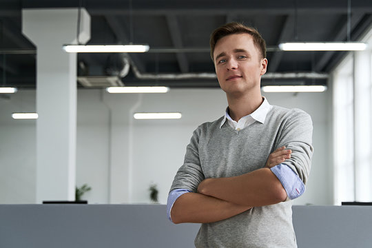 Portrait Of A Handsome Young Man Professional With Arms Crossed Looking At Camera In The IT Company Office