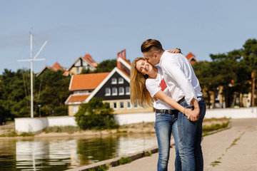 beautiful blonde and her boyfriend on the beach in summer