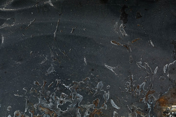 Background from the Black metal leaf with the abstract drawing. Stains and spots of rust