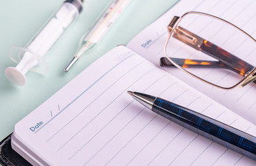 stethoscope (phonendoscope) a pen and glasses. The concept of the doctor's desktop