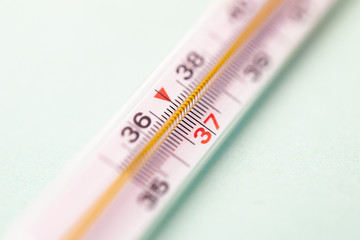 mercury thermometer isolated on white background, focus on 37 degree