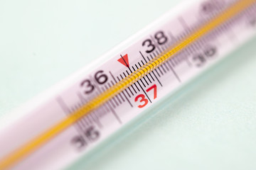 mercury thermometer isolated on white background, focus on 37 degree