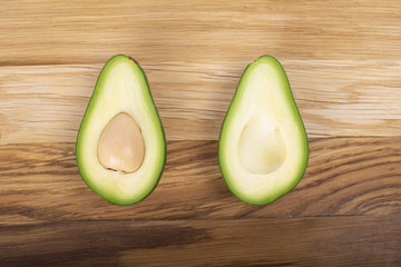 Avocado on a wooden board cut in half