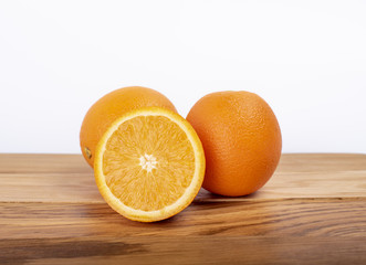 Orange on a wooden board, cut in half