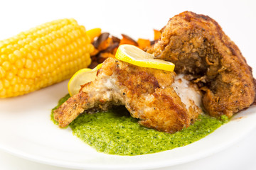 Fried Chicken on Bed of Pesto with Corn-on-Cob and Fried Sweet Potato