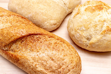 Assortment, different kind of wheat baked bread with golden crust on the table