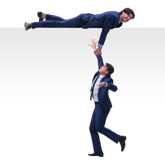 Businessman offering helping hand to falling colleague