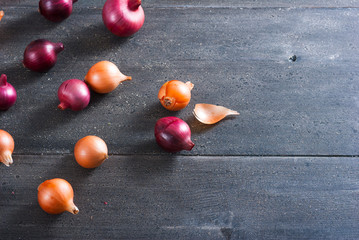 spanish and red onions on black wooden table