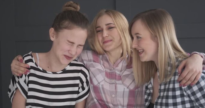 Three teen girl friends laughing