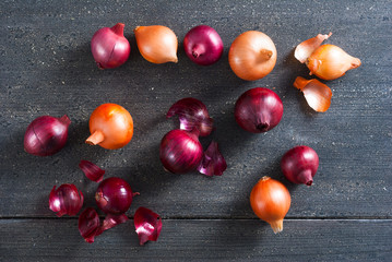 spanish and red onions on black wooden table
