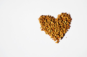 Granulated instant coffee in a shape of heart on a white background , love background,photo